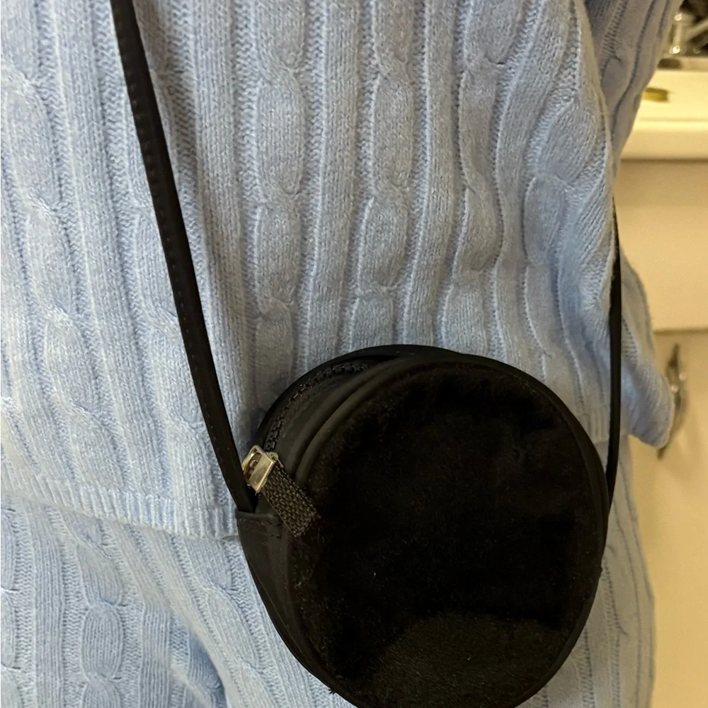 Women’s Round Black Crossbody Bag with zipper closure.